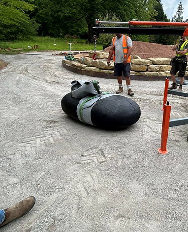 AC2200 crane lifting a large stone